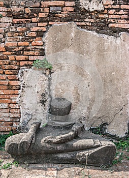 Ancient ruin of sitting buddha statue at old royal temple.