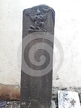 Ancient ruined pillar with garuda carving