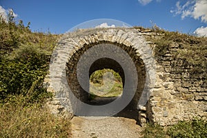 Ancient ruins of castle wall tunnel arch shape passage country side outdoor environment