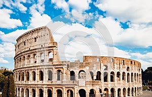 Ancient ruins Colosseum Rome, Italy, background blue sky with clouds