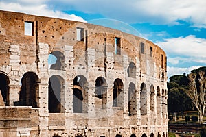 Ancient ruins Colosseum Rome, Italy, background blue sky with clouds