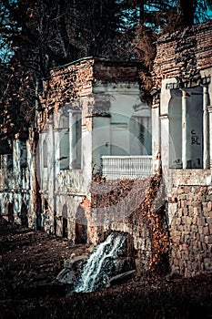 Ancient ruins with columns and waterfall