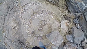 Ancient ruins of a fortified leper colony - Spinalonga Kalydon island, Greece climbing by stones female feet in sport