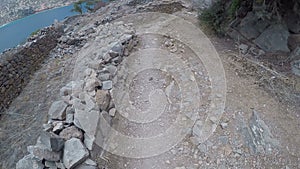 Ancient ruins of a fortified leper colony - Spinalonga Kalydon island, Greece climbing by stones pov