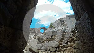 Ancient ruins of a fortified leper colony - Spinalonga Kalydon island, Greece climbing by stones pov