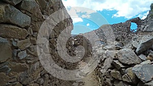 Ancient ruins of a fortified leper colony - Spinalonga Kalydon island, Greece climbing by stones pov