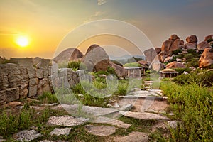 Ancient ruins in Hampi on sunset. India