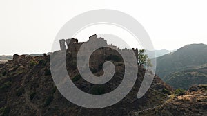 Ancient ruins of a medieval castle on top of the mountain. Amendolea Castle.