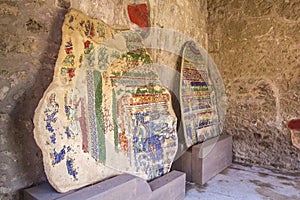 Part of the colored brick wall with painted frescoes in Pompeii, Naples, Italy. The ruins of the ancient city, excavations of Pomp