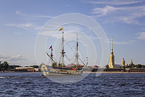Ancient Russian military sailing ship Poltava on the parade in Saint Petersburg in the Neva River against the background of the