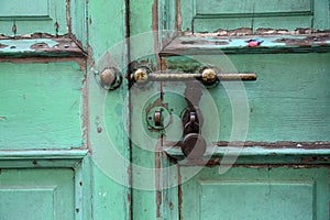 Ancient rusty door latch with padlock