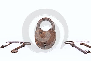 Ancient rusty padlock with collection of keys isolated on white background