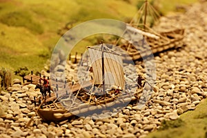 Ancient sailing ships near the river pier. Landscape layout with railroad, cars, residential and industrial buildings. Monuments