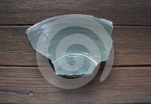 Ancient sample of bowl-piece, coarse stoneware body with light green glazed on interior.