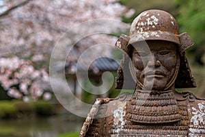 ancient samurai warrior statue in spring garden