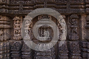 Ancient sculpture and stone carvings on the walls of the ancient 13th century sun temple at Konark, Odisha, India.
