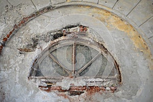 Ancient semicircular window in vintage building