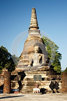 An ancient Siamese Buddha sits in front of Wat Sa Si in Sukothai Historical Park in northern Thailand