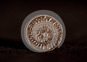 Ancient silver Armenian coin with lion portrait isolated on black, close-up shot.