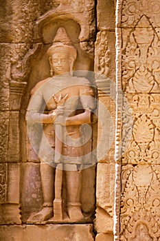 Ancient soldier bas-relief on a wall at Banteay Kdei temple ruins, in Angkor Wat complex near Siem Reap, Cambodia.