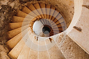 An ancient spiral stone staircase in Fort Mamula in Montenegro photo
