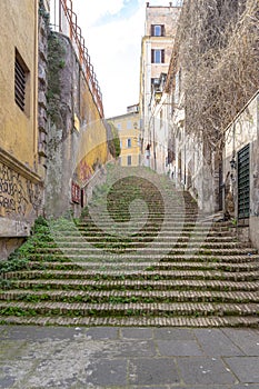 ancient staircase with weeds on a street in Via de san Onofrio in Rome.