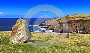 Ancient Standing stone above rugged and wild coastline