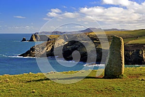 Ancient Standing stone above rugged and wild coastline