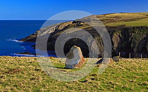 Ancient Standing stone above rugged and wild Pembroke coastline