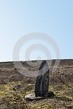 Ancient standing stone or megalith on midgley moor in calderdale west yorkshire surrounded by scattered rocks possibly once a