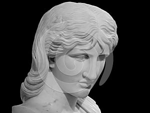 Ancient statue head isolated on black background. Barbarian woman known as Thusnelda. Marble sculpture