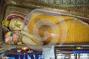 Ancient statue of lying buddha at buddhist temple