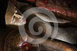 Ancient statue of a recumbent Buddha in the cave temple of Dambulla. Sri Lanka