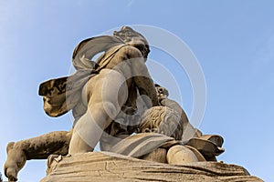 The ancient statue of the Three cherubs (winged angle cupids) playing on a column