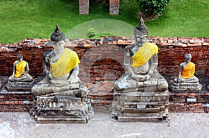 Ancient statues of Buddha of different sizes, in the old temple of Wat Yai Chaimongkol in Ayutthaya, Thailand.