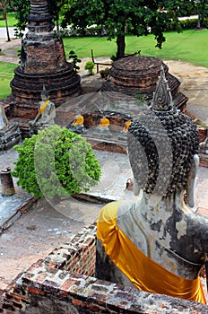Ancient statues of buddha sitting, at Wat Yai Chaimongkol at Ayutthaya National Park, Thailand.