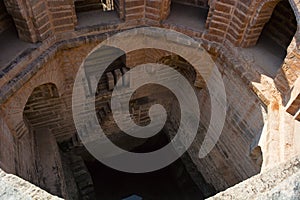 Ancient step well with windows and steps