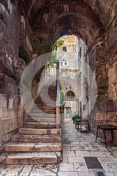 Ancient stone arch passage with steps in old town Split in Croatia