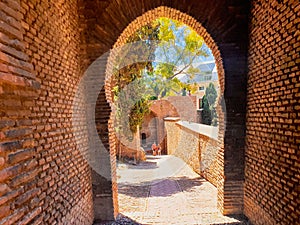 ancient stone archway, gate of the wall and the gardens of the Alcazaba in the city of Malaga, Andalusia. Spain photo