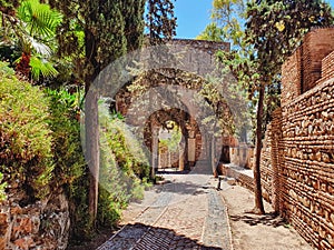 ancient stone archway, gate of the wall and the gardens of the Alcazaba in the city of Malaga, Andalusia. Spain photo