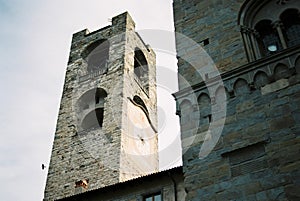 Ancient stone bell tower with a clock in Bergamo. Italy