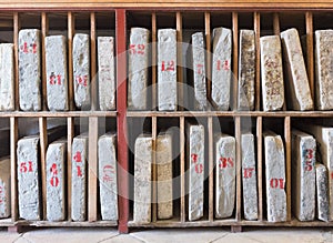 Ancient stone books on bookshelves. Education and knowledge. Archive