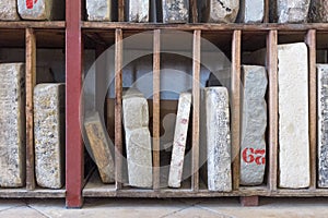 Ancient stone books on bookshelves. Education and knowledge. Archive