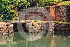 Ancient stone bridge across a canal on the road to the fortress of Sigiriya Lion Rock