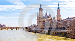 Ancient stone bridge and Cathedral from Ebro river. Zaragoza, Ar