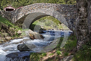 Ancient stone bridge over the Comas river