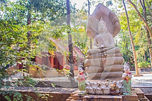 Ancient stone Buddha image statue at Wat Umong Suan Puthatham, a 700-year-old Buddhist temple in Chiang Mai, Thailand. Wat Umong i