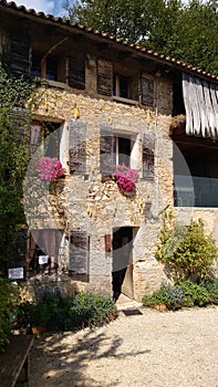 A ancient stone building with flowers in northwestern Italy