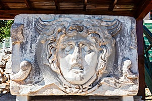 Ancient stone carving of Medusa Head. photo