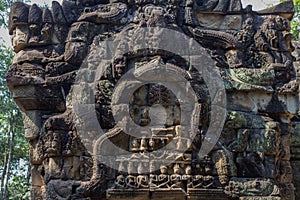 Ancient stone carving of Ta Prohm temple, Angkor Wat complex, Cambodia. Carved gate of temple ruin.